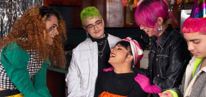 A group of friends of varying genders celebrating